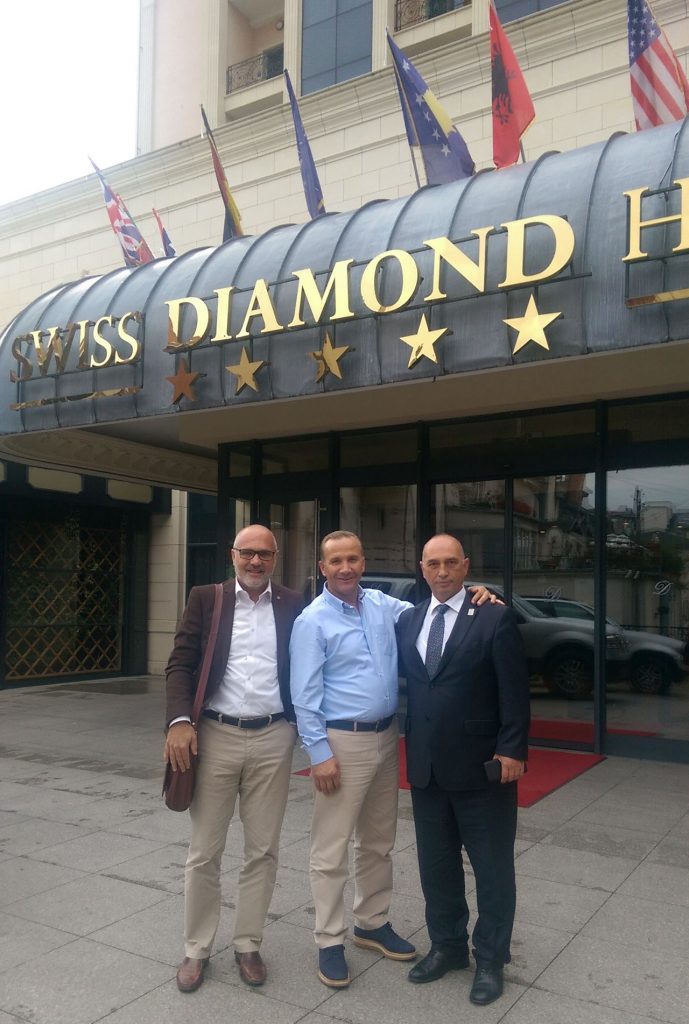 Damjan Pintar with partners in front of a hotel