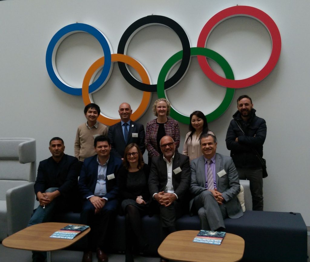 group photo under the olympic logo