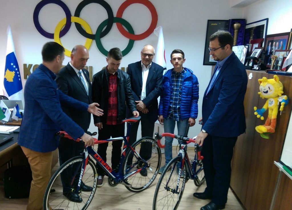 handing over bikes to young athletes