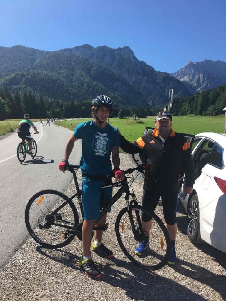 young cycler and his coach