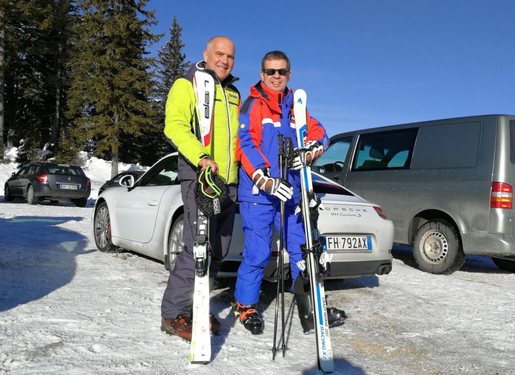 two skiers in a parking