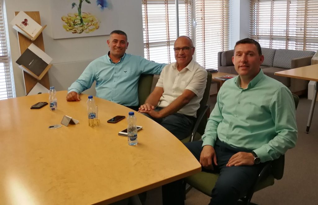 three men at a conference table