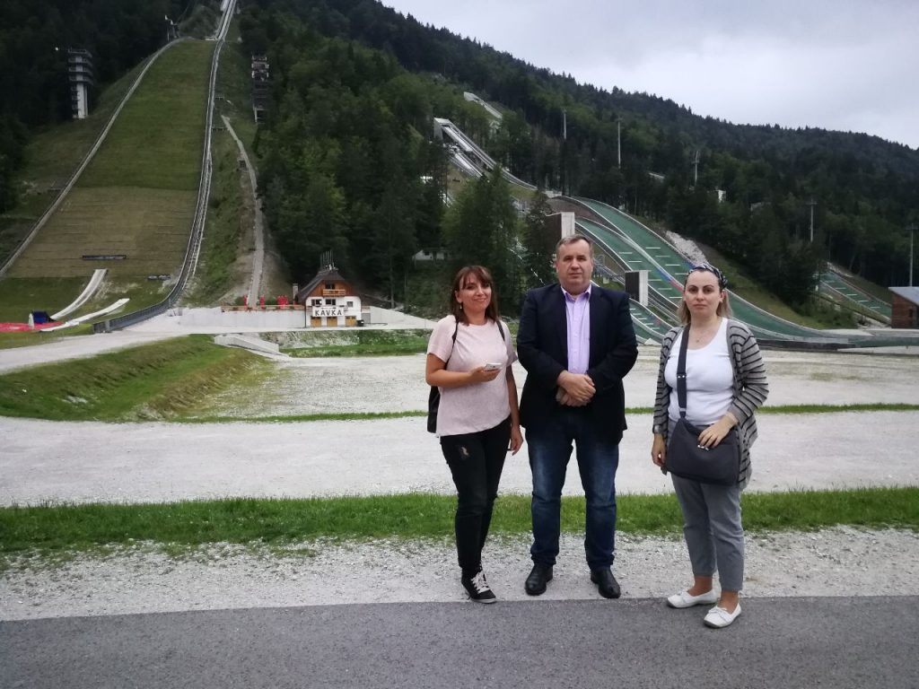 three people in fornt of Letalnica